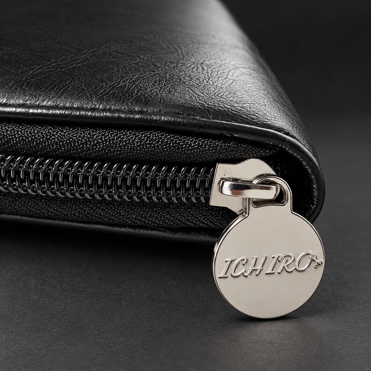 Silver Ichiro logo zipper pull on the black shear travel case